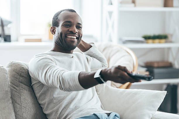 Young African Man Watching TV