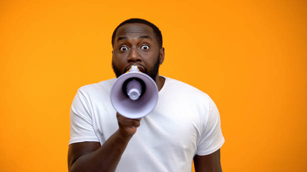 African man making announcement with a megaphone.jpg