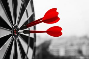 Dart board with three darts outdoors.