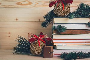 Books- gifts for Christmas with decoration on a wooden background