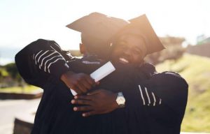 Two friends hugging each other at graduation