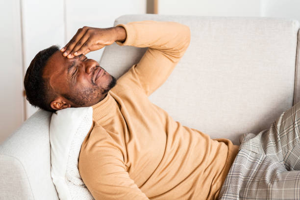 Young African American man looking tired after work