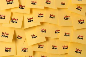 Adhesive notes with 'Now' written and 'Later' cancelled. An anti-procrastination image