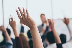 Hands raised to ask a question at a lecture