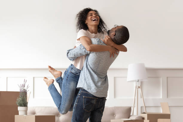 African husband lifting happy wife laughing