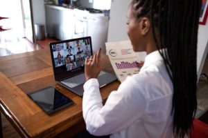 Woman working from home having a video conference with business partners.