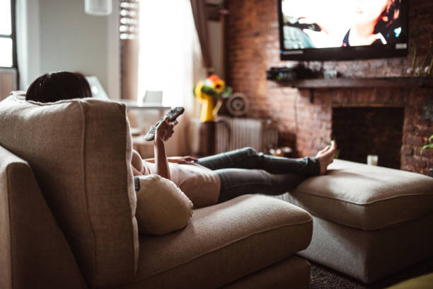 Woman looking the TV at home