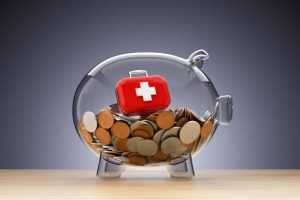 Piggy Bank with a First Aid Kit- Health Insurance Concept
