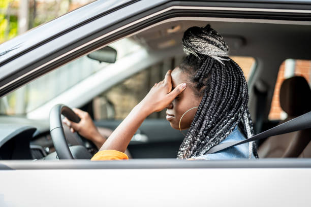 A young female driver looking stressed