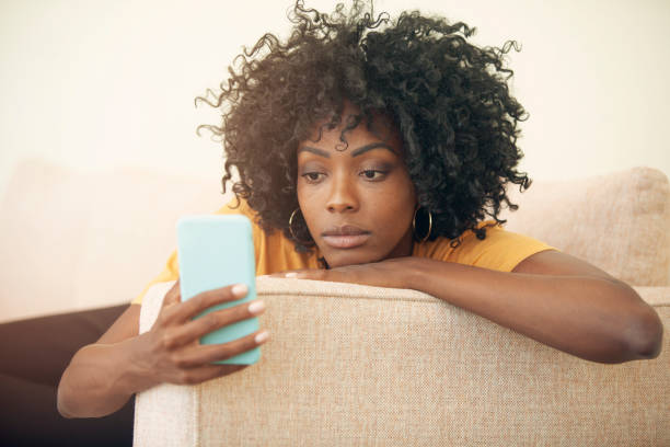 Adult woman looking at her phone, expecting something