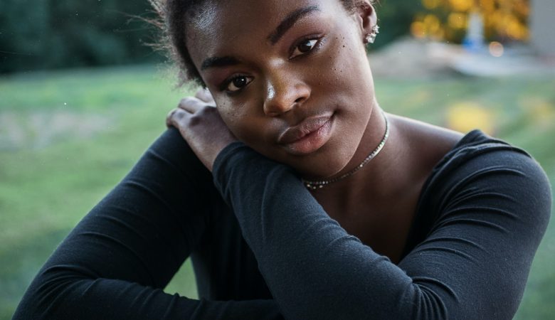 Young lady sitting down and staring into the camera