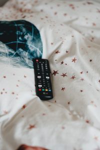 A TV remote placed on a large piece of cloth