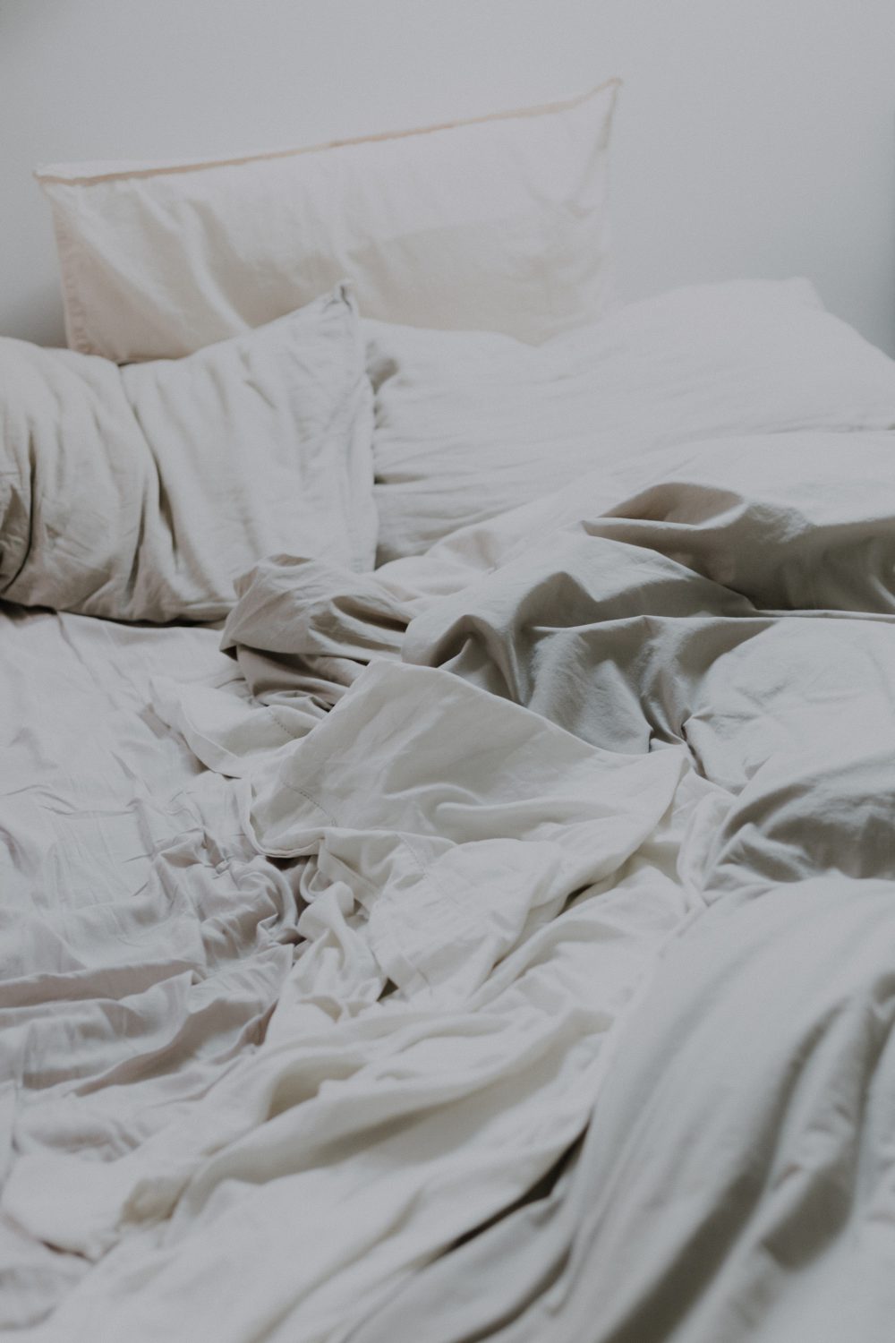 A scattered bed with white, rumpled sheets