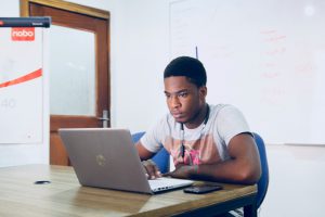 A young man working on a laptop