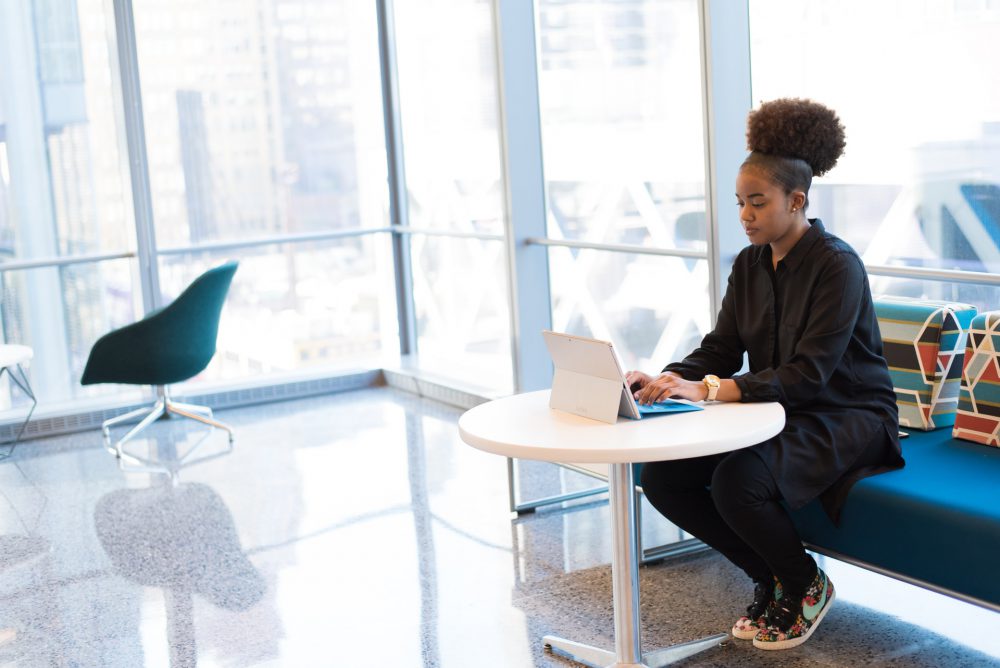 A young lady sitting down and working